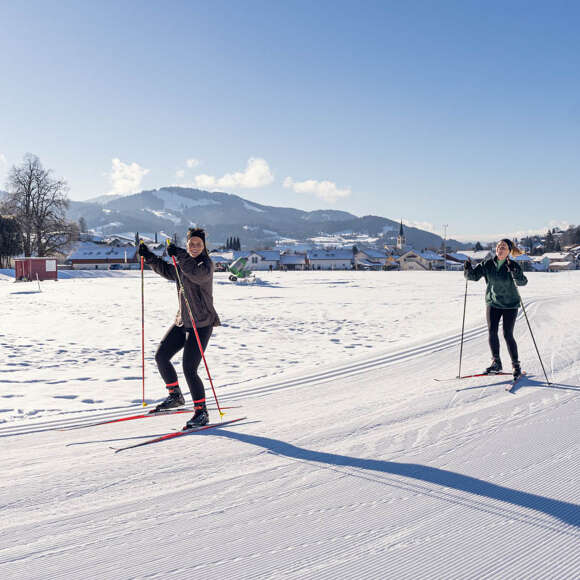 Spaß beim Langlaufen auf der Kalzhofer Loipe bei strahlendem Sonnenschein.