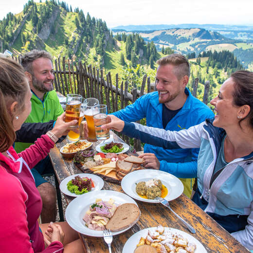 Einkehr mit Essen und Trinken beim Wandern auf dem Staufner Haus mit Weitblick auf die Landschaft.